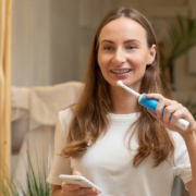 bigstock Woman Brushing Teeth And Readi 444123860
