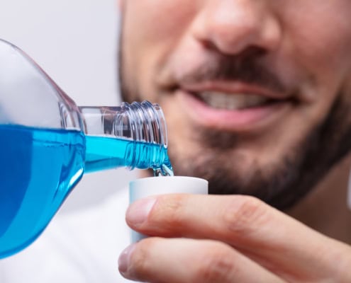Man Pouring Mouthwash In To Cap